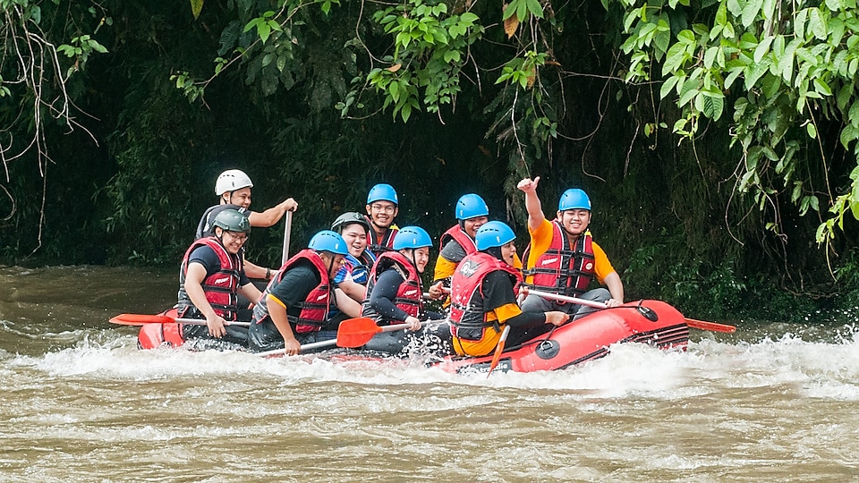 People enjoying river rafting